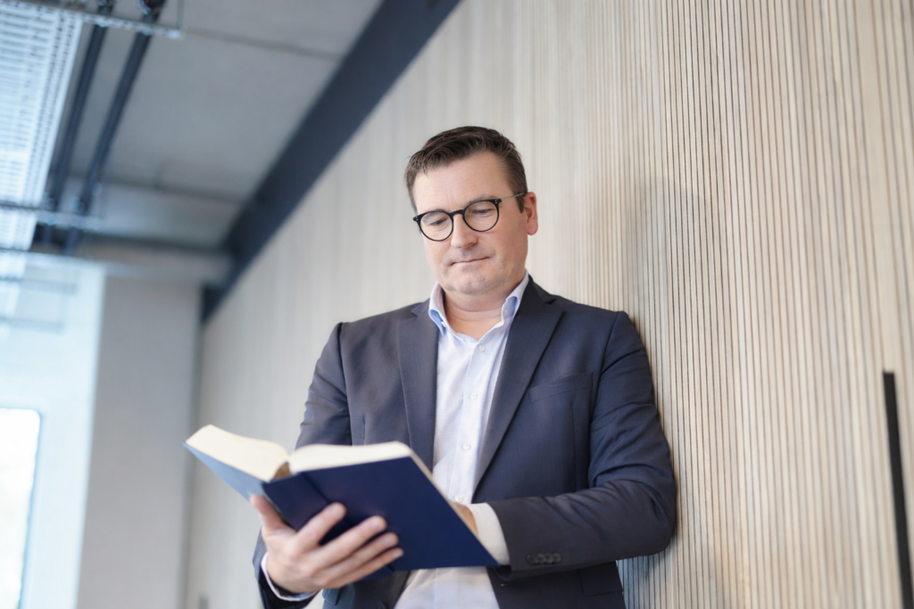 Man reading a book in office